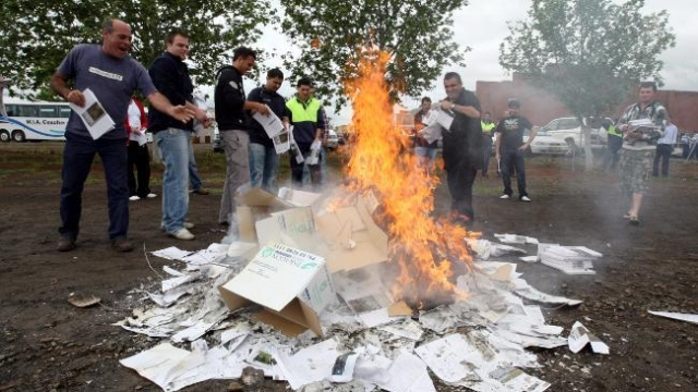 Men burn copies of the Murray-Darling draft plan in the NSW town of Griffith as anger mounts over the proposed cuts. Picture: Nathan Edwards