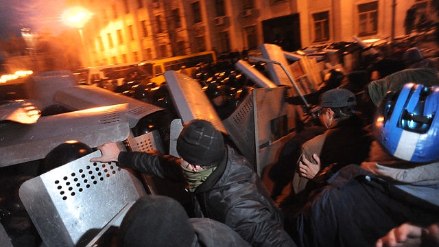 Riot police (Bekrut), defending the Kiev city council building, and protesters, Violent outcome of the clash at Bankova str, Kiev, Ukraine. December 1, 2013